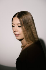Portrait of a woman in a studio with professional lighting in a smart dress with gloves