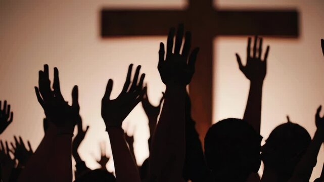hands of a crowd of people at a Christian meeting during the glorification praise of God against the background of the cross