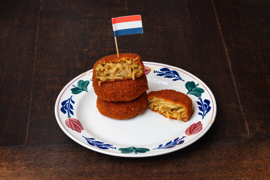 Bamischijf on the plate decorated with dutch flag, dutch snack consisting of breaded and deep fried bami noodles
