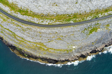 Black Head Lighthouse, situated in the rough rocky landscape of Burren, amidst a bizarre scenery of...