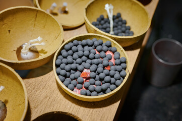 Crafting vibrant fireworks: intricate preparations within a bustling factory setting