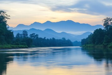 Serene River Flowing Through Lush Forest with Majestic Mountains in the Background at Sunset in a Tranquil Natural Landscape Setting