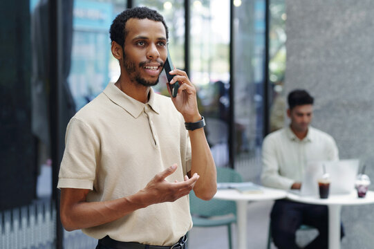 Businessman having conversation on mobile phone while working in office