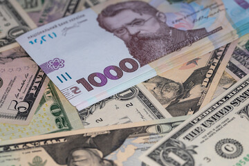 100 dollar and 1000 hryvnia banknotes