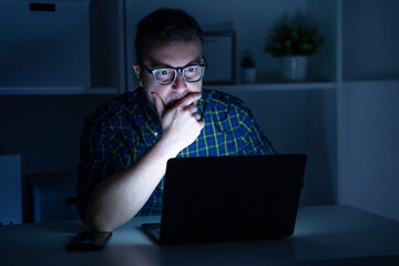 Portrait of shocked man reading bad news on laptop