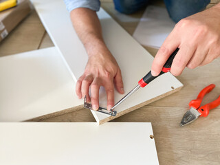 Man assembling new furniture at home do-it-yourself concept