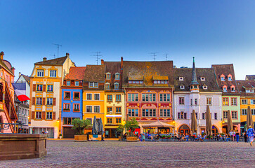 Mulhouse cityscape, typical houses colorful buildings and street restaurant outdoor café on Place de la Reunion square in old town Mulhouse city historic centre, Alsace Grand Est region, France