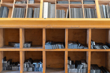 Organized metal letter blocks in wooden drawer