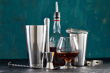 Set of stainless bar or pub accessories with a glass and cocktail shaker. Bartender cocktail...