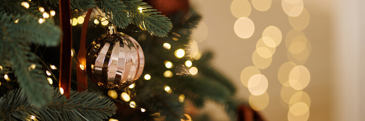 Christmas tree with golden decoration and lights garland close-up with copy space. Banner with copy space. Banner with copy space. © Kaplitskaya Love