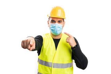 Constructor pointing at mask and camera as covid19 prevention