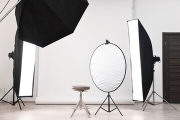 Professional lighting equipment setup in modern photo studio