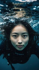 Fototapeta premium Underwater Serenity: A Woman's Tranquil Dive