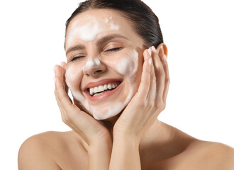 Smiling woman washing her face with cleansing foam on white background