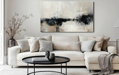 Elegant contemporary living room featuring a soft cream sofa, a round black metal coffee table, neutral-toned cushions, and a large abstract canvas
