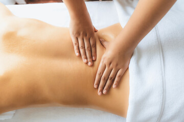 Closeup woman customer enjoying relaxing anti-stress spa massage and pampering with beauty skin recreation leisure in day light ambient salon spa at luxury resort or hotel. Quiescent