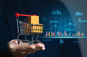 Businessman holding shopping cart with boxes and sales charts. Retail concept and sales statistics....