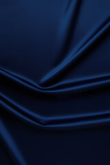 Fototapeta premium Deep blue matte fabric texture with flowing folds and soft gradients. Perfect as a stylish and sophisticated background for graphic design, photography, or branding