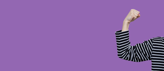 Banner IWD2025 Accelerate action. AccelerateAction. International Women's Day. 8 march day. Faceless Women's hand on purple background. Strong, power, strength demonstrate