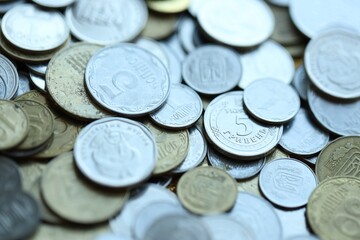 Metal coins of Ukraine of different denominations are scattered. Money texture, business background.