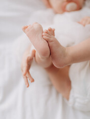 feet and hand of a newborn baby close-up