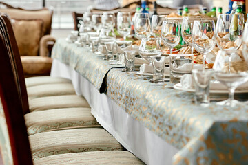 Elegant Banquet Table with Decorative Glassware and Chairs.