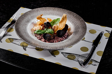 Seafood Risotto with Mussels and Basil on Decorative Plate.