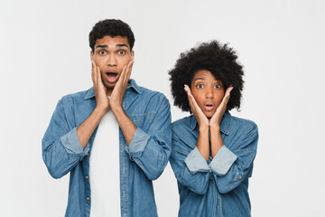 Young shocked scared couple two friends family man woman of African American ethnicity wear denim...