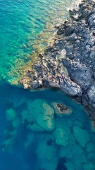 Cinematic aerial view from top about a white little boat running in a hypnotic blue colored sea