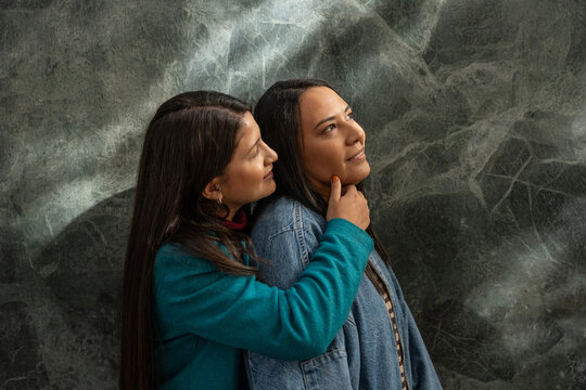 Loving embrace of a Latin lesbian couple conveying warmth