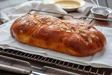 Fresh baked tsoureki braid. Easter sweet bread on the table, blur kitchen background