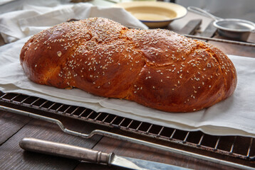 Fresh baked tsoureki braid. Easter sweet bread on the table, blur kitchen background
