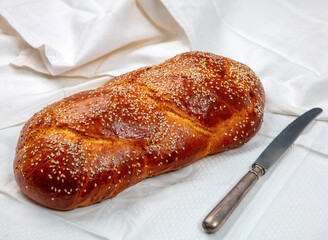 Easter sweet bread, homemade tsoureki braid on white table cloth