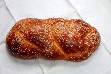 Easter sweet bread, Greek tsoureki braid on white table cloth, top view