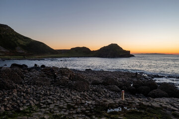 Giant's Causeway at sunset, featuring the iconic hexagonal steps prominently in the foreground