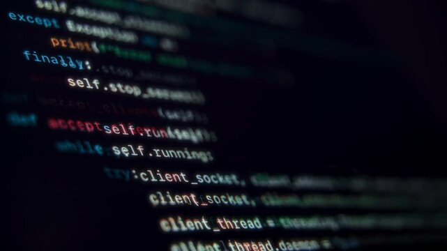 Close up of programming code running on dark computer screen. Programming and coding concept.
