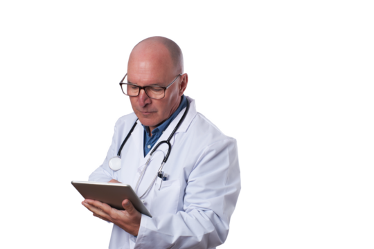A medical professional in a white coat checks a tablet for patient details in a well-lit healthcare setting during daytime hours.