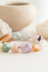 Fototapeta premium Vibrant gemstone bracelet showcasing a stunning array of colors on a light tabletop setting