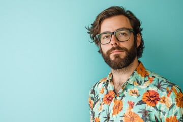 Obraz premium Stylish Man with Beard in Floral Shirt Against a Turquoise Background