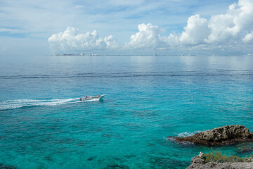 Rocky Caribbean Sea coastline with rocks and azure water.