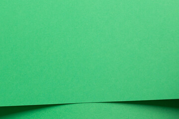 Eden green paper background with smooth, layered sheets and a fine matte finish. Vibrant, fresh tones and overlapping geometric elements create a bold, elegant, and polished design with a modern and