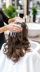 Naklejka premium Professional hair treatment at a modern salon in the city with a stylist washing a client's long, wavy hair during a relaxing experience