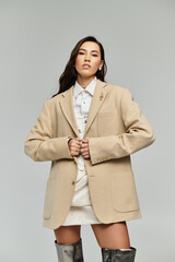 A confident young woman looks elegant in a chic oversized blazer.