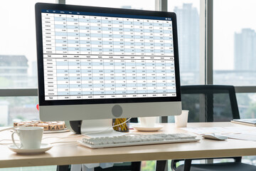 Accounting software on computer screen showing financial statement spreadsheets and account balance...