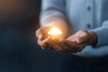 Man holding glowing cloud symbol in hands indoors during evening