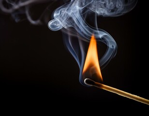 a wooden match that lights up and emits smoke on a black background