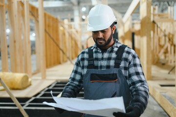 Construction of modular houses. Indian construction worker or engineer at construction site