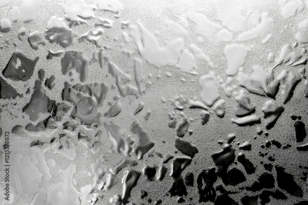 Poster Abstract grayscale image showcasing textured water droplets on a glass surface, creating a unique pattern.