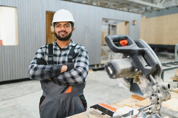Indian carpenter works on the construction of modular houses