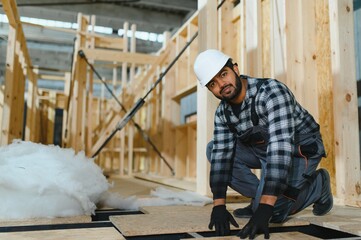 Construction of modular houses. Indian construction worker or engineer at construction site